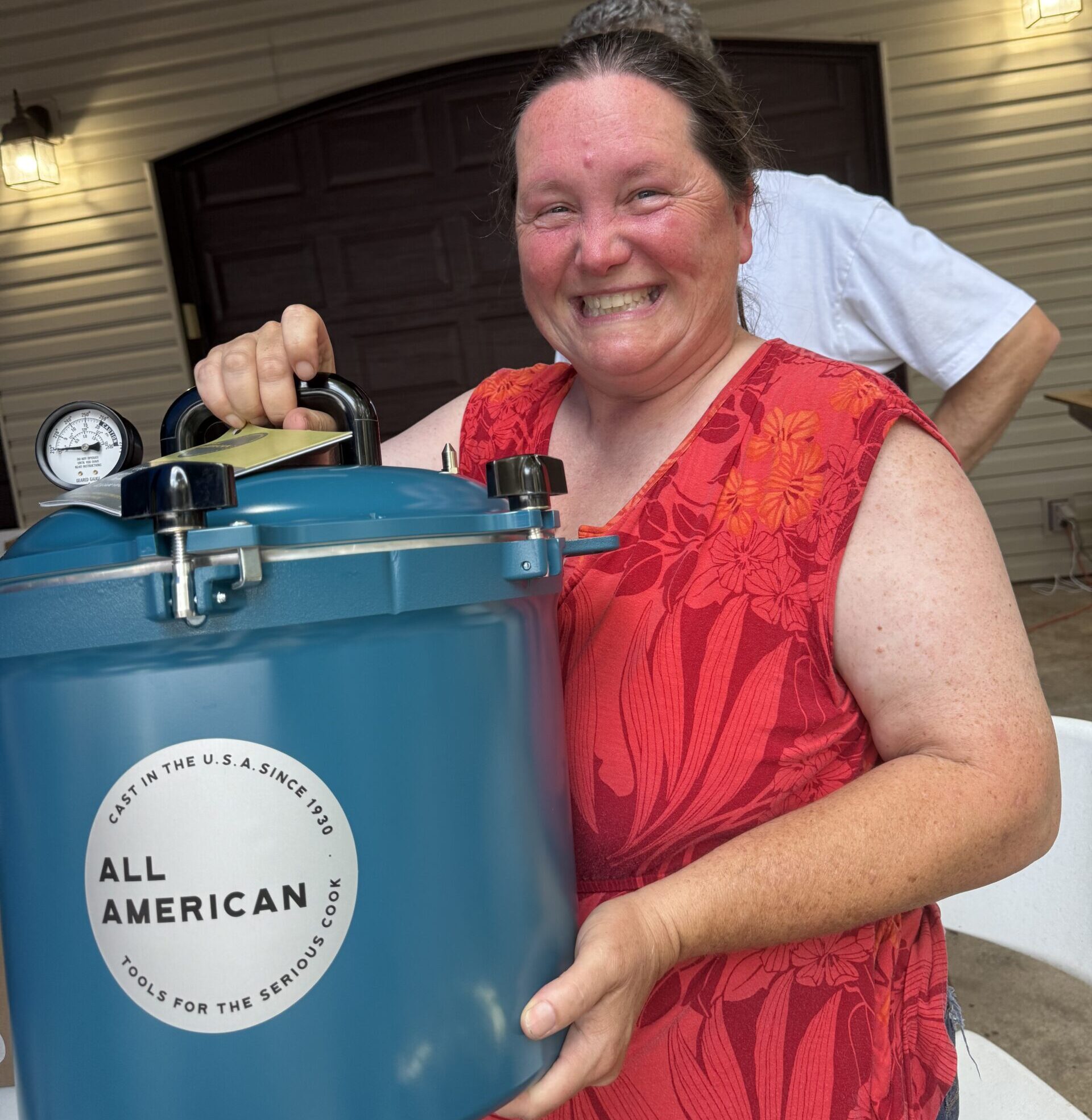 Brenna holding a pressure canner starting her full time homestead life